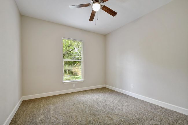 Carpeted empty room featuring plenty of natural light and ceiling fan | Image 22