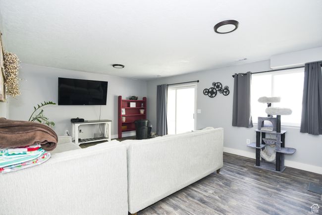 Living room with visible vents, wood finished floors, and baseboards | Image 19