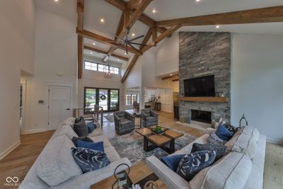 Great Room with floor to ceiling fireplace, automatic blinds, soaring beamed ceilings and beautiful engineered hardwoods. | Image 3