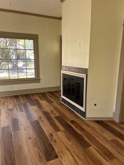 Unfurnished living room with dark wood-type flooring and crown molding | Image 3