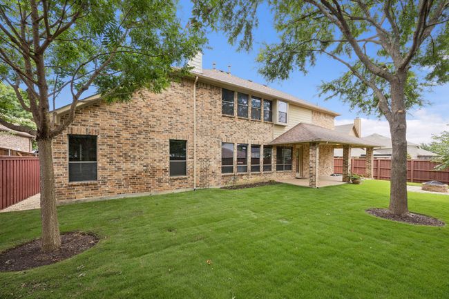 Back of house featuring a chimney, a patio, and brick siding | Image 36