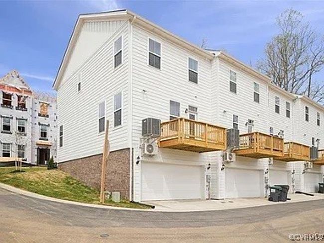 Rear view of property featuring a garage and a​​‌​​​​‌​​‌‌​‌‌​​​‌‌​​‌‌​‌​​​​​‌ balcony | Image 5