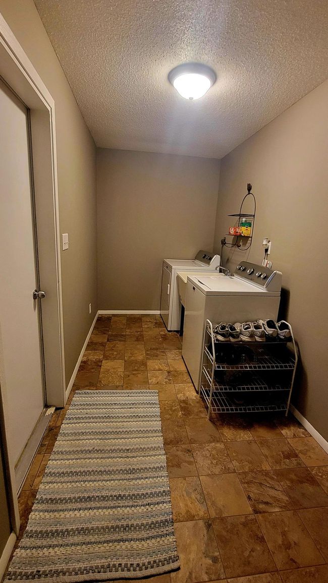 Rare main level laundry room with door leading to attached garage | Image 21