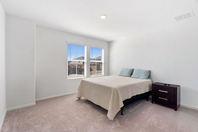 Bedroom featuring light carpet, visible vents, and baseboards | Image 25