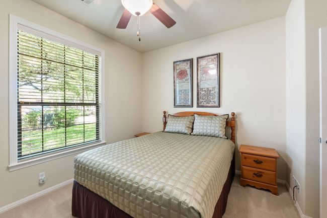 Bedroom featuring light carpet and ceiling fan | Image 20