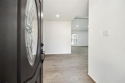 The entry area of the home is spacious, flowing openly into the den and kitchen. | Image 3