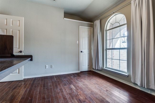 Unfurnished dining area featuring baseboards, lofted ceiling, and dark wood-style floors | Image 17