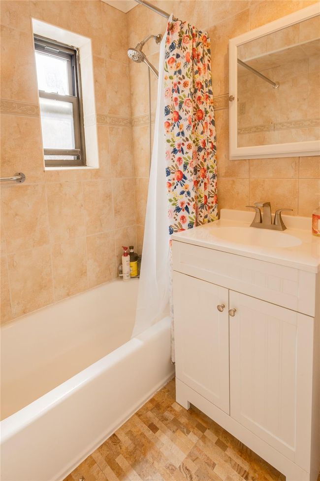 Bathroom featuring shower / bath combination with curtain and vanity | Image 15