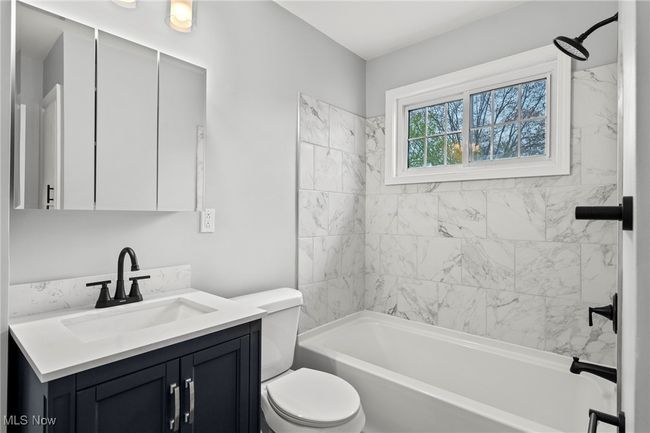 Full bath featuring toilet, bathing tub / shower combination, and vanity | Image 24