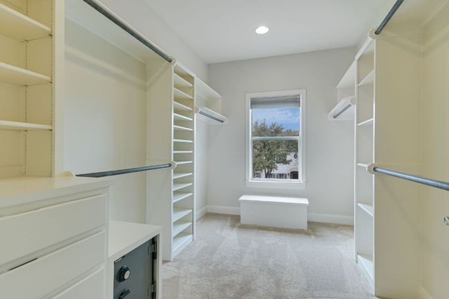 One of two spacious primary closets with custom built-ins and natural light. | Image 22