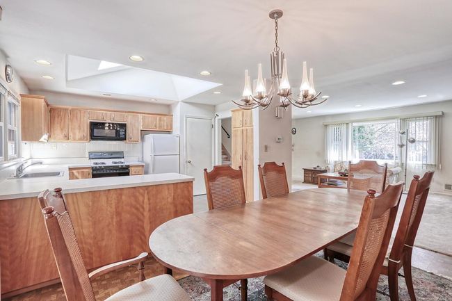 Dining space featuring stairway, an inviting chandelier, and recessed lighting | Image 7