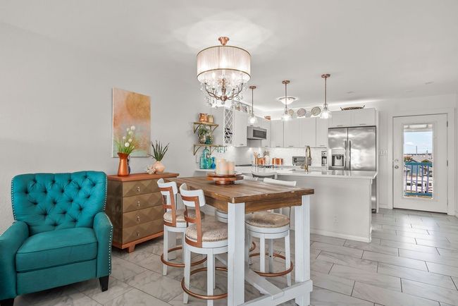 Open kitchen living and dining with unique coastal chic light fixtures | Image 14