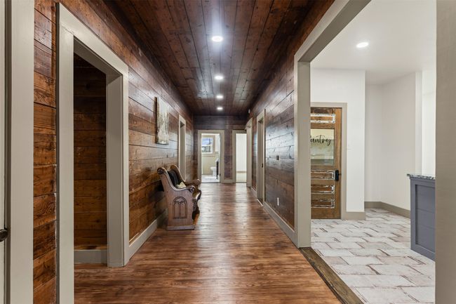 Hallway featuring wood walls, wood ceiling, recessed lighting, wood-type flooring, and baseboards | Image 21