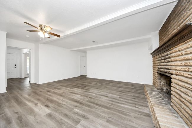 View from the sliding doors into the living room and the front door and flex room | Image 7
