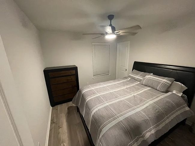 Bedroom featuring wood finished floors and a ceiling fan | Image 7