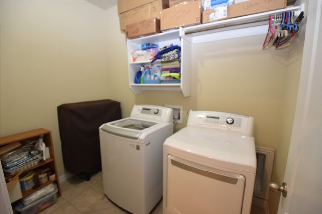 Great extra storage and shelving highlight the laundry room. | Image 16