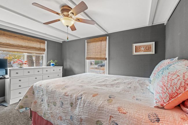 Bedroom featuring carpet flooring, multiple windows, ceiling fan, and beam ceiling | Image 21