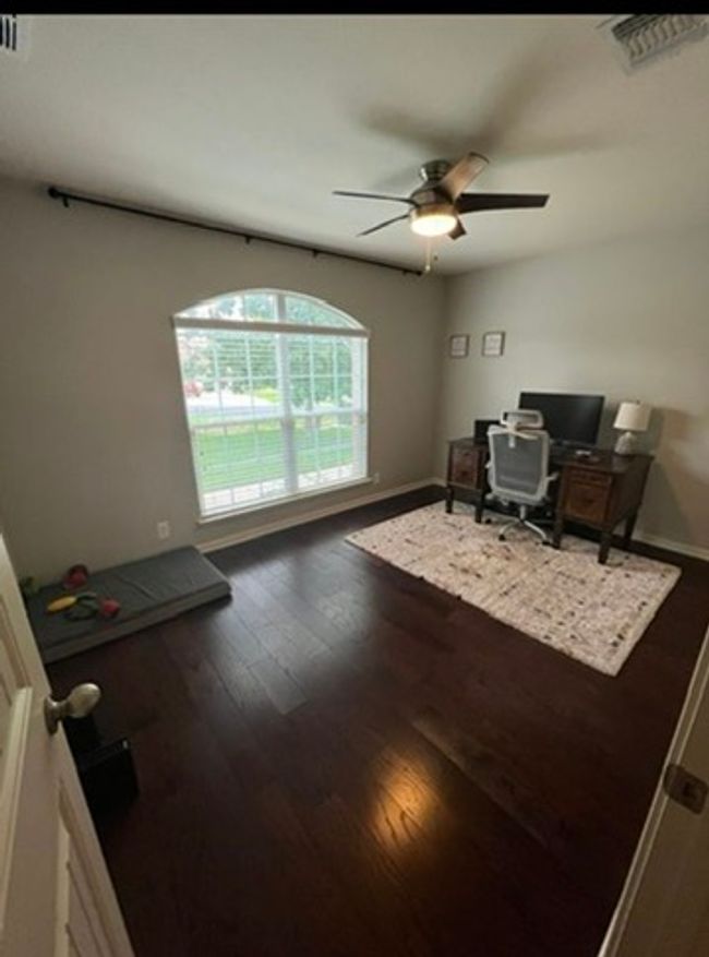Office with a ceiling fan and wood finished floors | Image 13