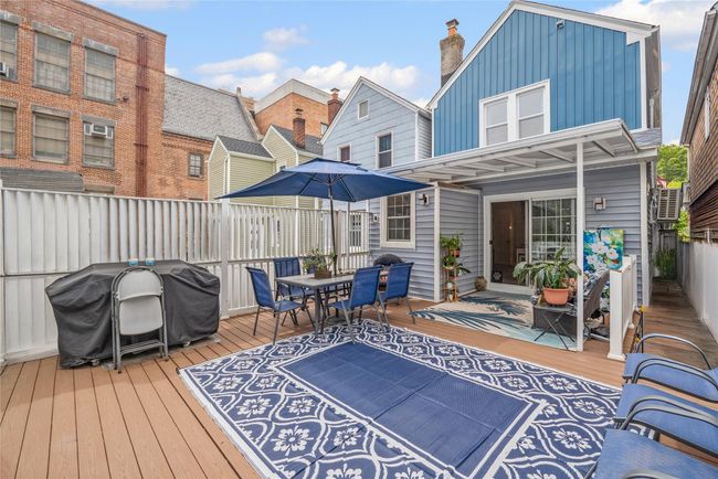 Wooden terrace featuring outdoor dining area and area for grilling | Image 32
