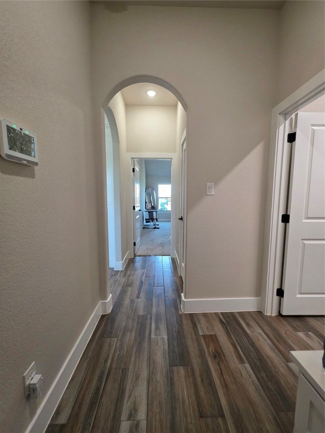 Corridor with arched walkways and dark wood-style floors | Image 19