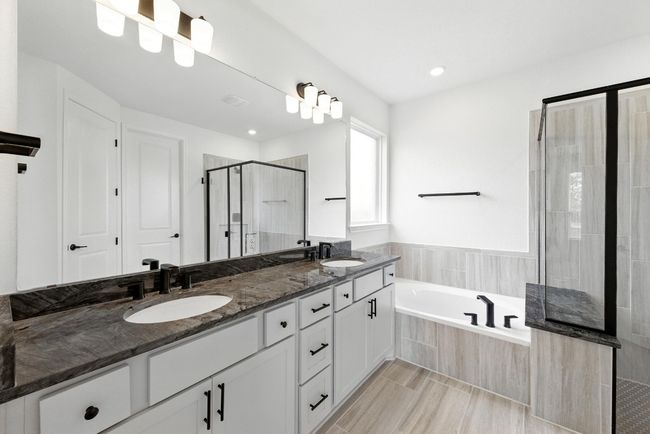 Bathroom with a stall shower, a bath, double vanity, and recessed lighting | Image 19