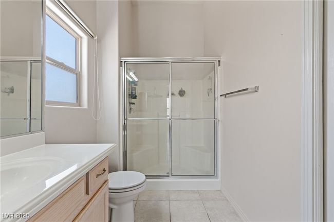 Full bath with a stall shower, vanity, and tile patterned floors | Image 26