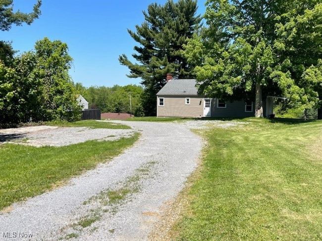 View of back of home showing yard on both sides of Shared Drive to Back House | Image 24
