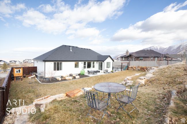 Rear view of house featuring a mountain view, a yard, and a patio area | Image 45