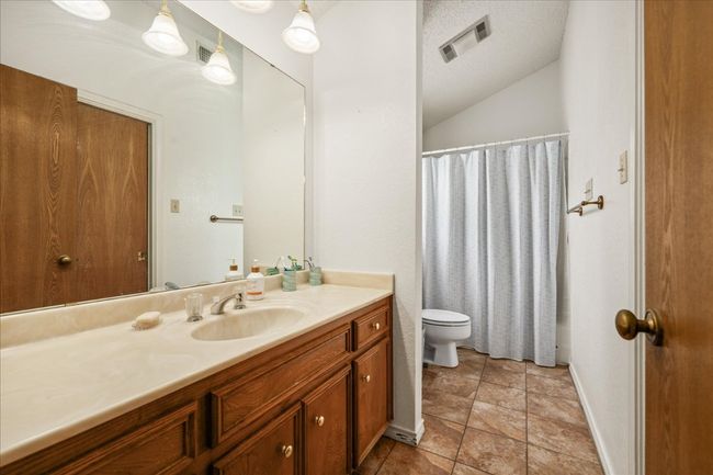 Full bath with vanity and lofted ceiling | Image 22