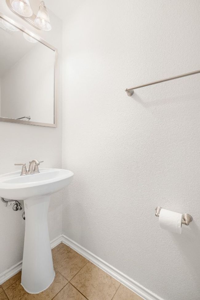 Bathroom with baseboards, tile patterned flooring, and a sink | Image 17