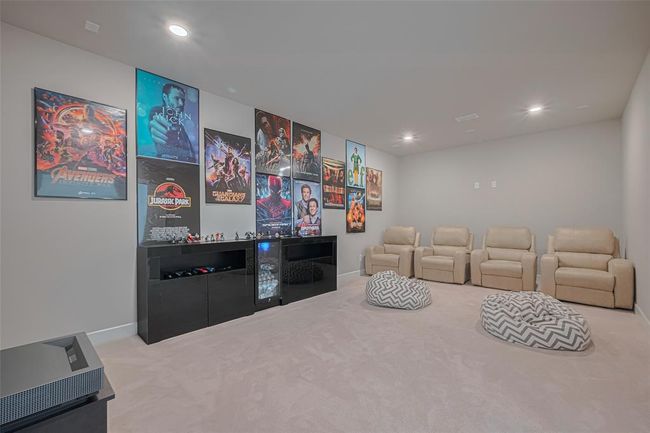 This is a cozy home theater room is ideal for movie or sports enthusiasts. | Image 35