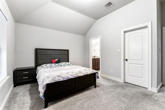 Here’s another view of this spacious guest room, which features an attached bathroom. All the rooms in the home are generously sized, with ample closet space and their own attached bathrooms, offering both privacy and comfort for everyone. | Image 35