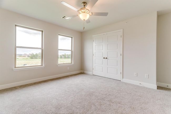 Unfurnished bedroom with a closet, ceiling fan, and carpet | Image 19