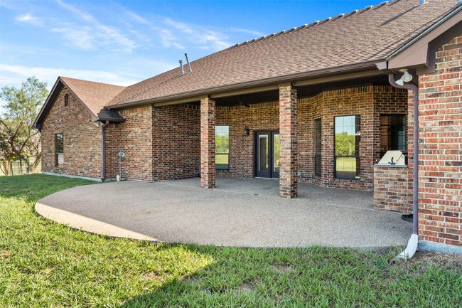 Back of property featuring brick siding, a patio area, and a yard | Image 29