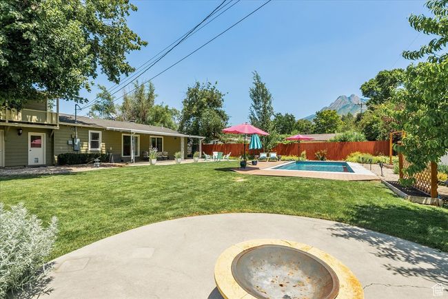 Fenced backyard featuring a patio area and a mountain view | Image 49