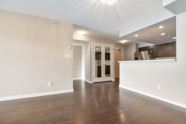 Unfurnished living room featuring dark wood-style flooring and recessed lighting | Image 10