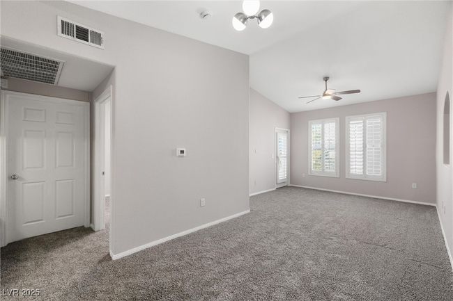 Spare room with lofted ceiling, visible vents, and carpet floors | Image 10