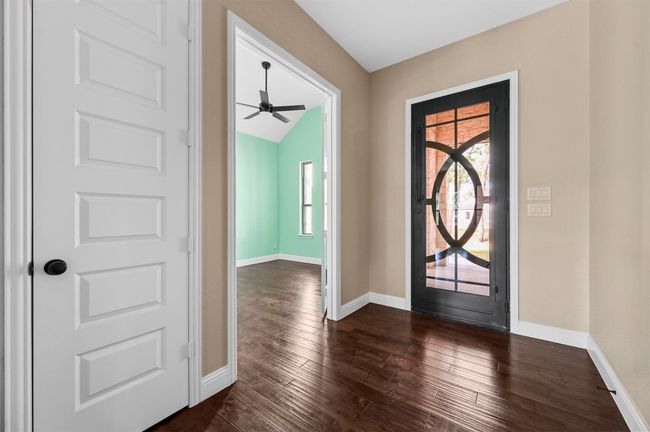 Entrance foyer with baseboards and dark wood-style flooring | Image 17