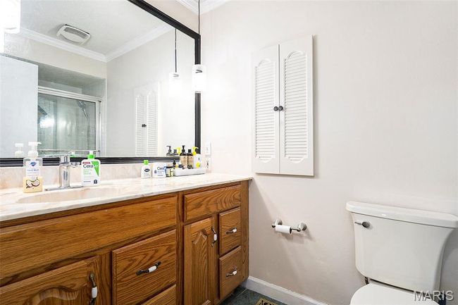 Full bathroom with ornamental molding, vanity, and a stall shower | Image 12
