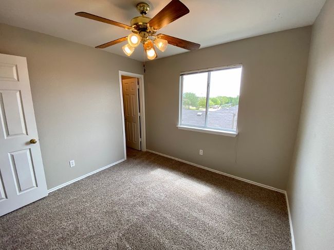 Unfurnished room featuring carpet floors and a ceiling fan | Image 26