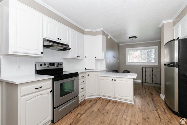 Unfurnished room featuring baseboards, dark carpet, a ceiling fan, and a textured ceiling | Image 12