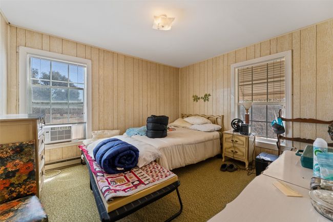 Carpeted bedroom with baseboard heating and cooling unit | Image 12