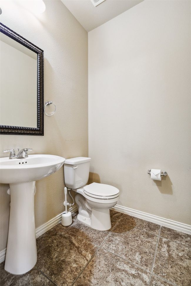 Bathroom with baseboards, toilet, tile patterned flooring, and a sink | Image 28