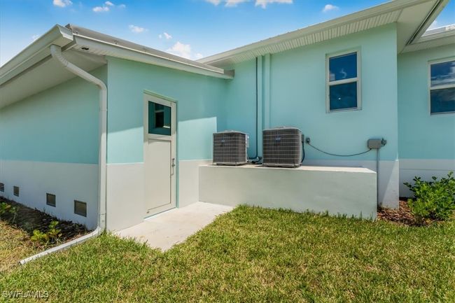 View of property exterior with stucco siding and a lawn | Image 35