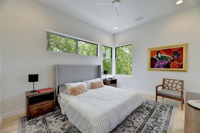 Bedroom with light wood-type flooring, baseboards, visible vents, and recessed lighting | Image 11