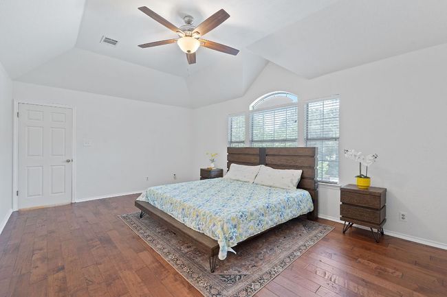 Bedroom with wood-type flooring, lofted ceiling, and a ceiling fan | Image 18