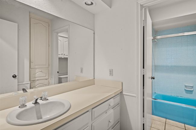 Bathroom with shower / washtub combination, vanity, and tile patterned floors | Image 19
