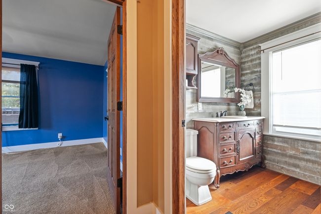 bathroom with healthy amount of natural light, vanity, and dark wood-style floors | Image 40