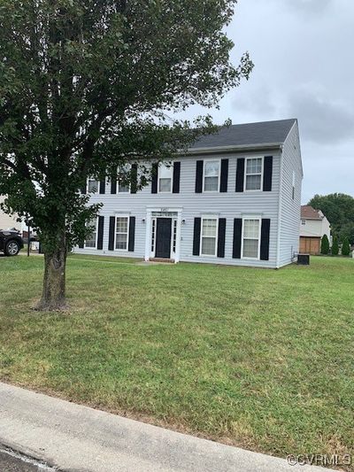 Colonial inspired home featuring a front yard | Image 1