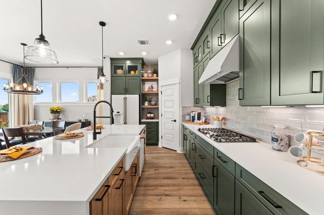 Quartz countertops provide ample workspace and elevate the overall aesthetic. | Image 7